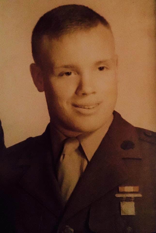 Young man in military uniform smiling, portrait image for Well Beings.