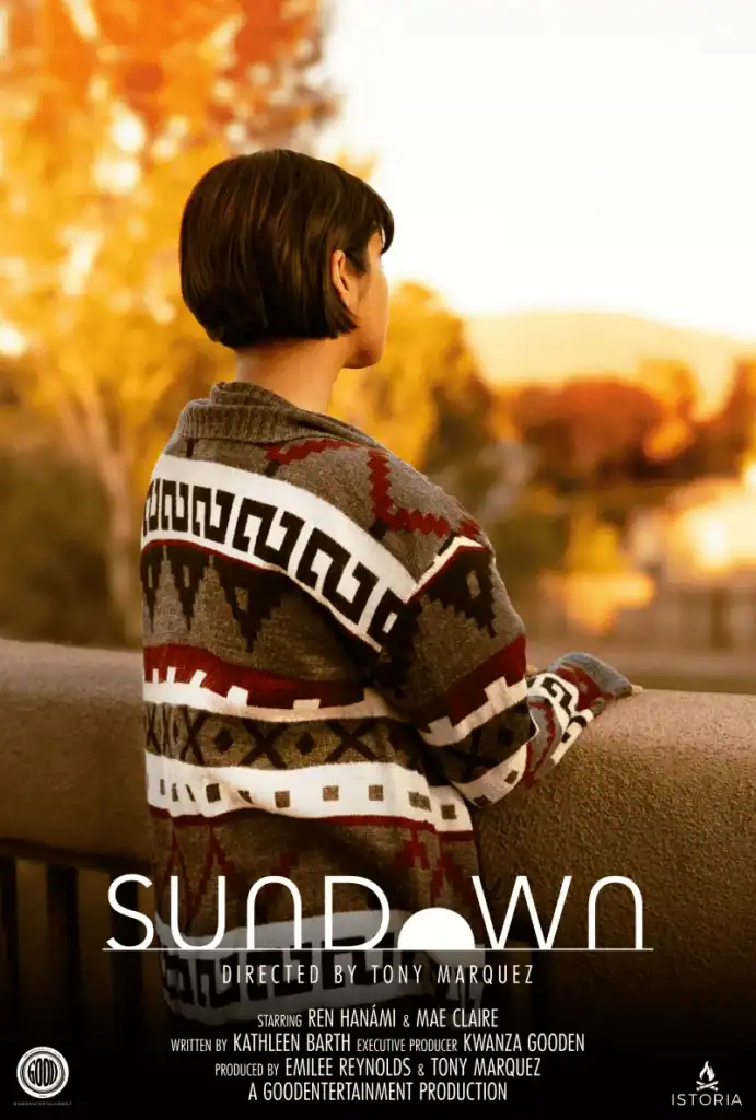 Person watching sunset with autumn trees in background, cozy sweater, peaceful scene.