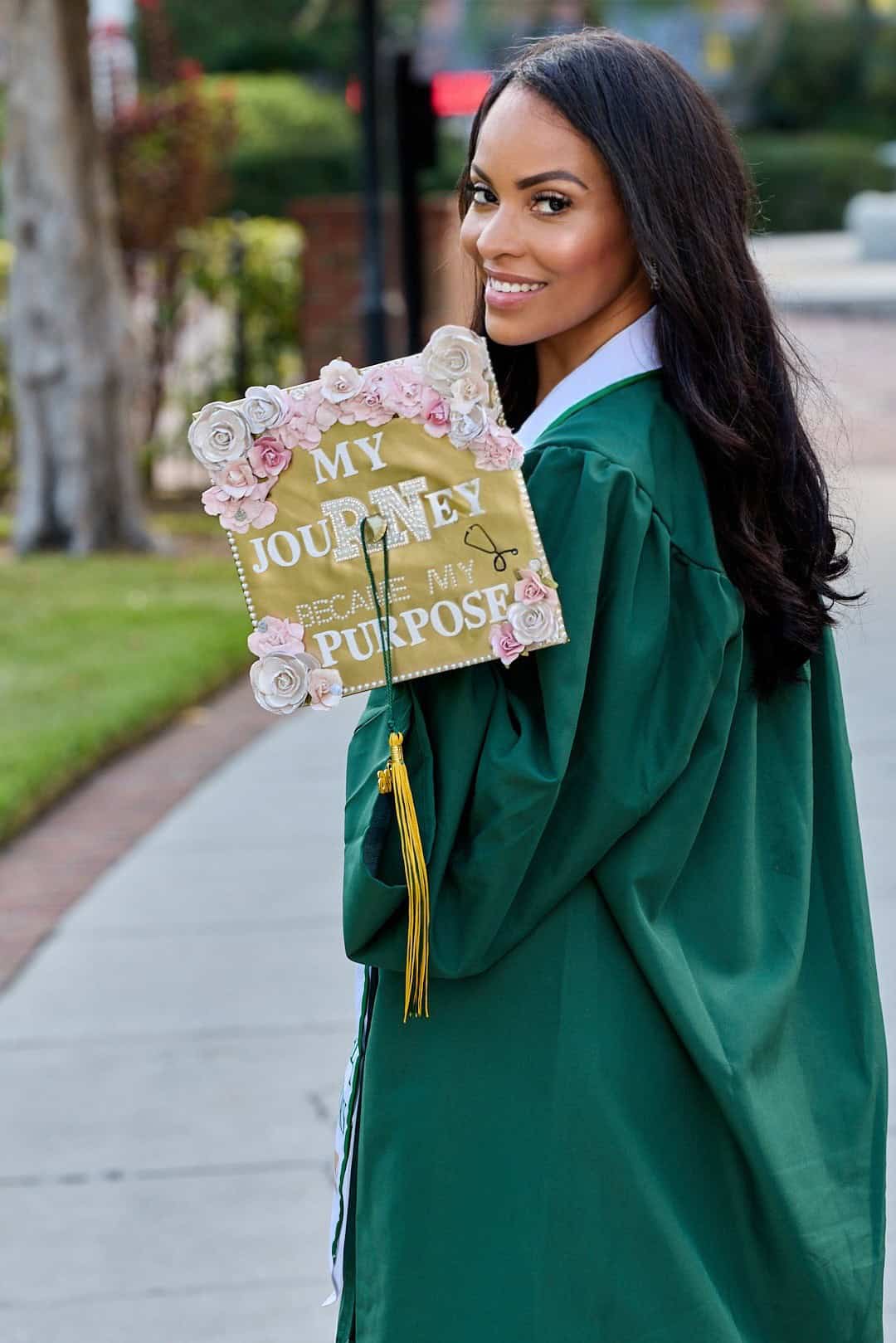 Alicia in her nursing school graduation gown, holding a cap decorated with the words My Journey Became My Purpose